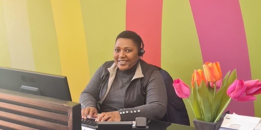 Bandi behind desk 2 | Vox | Our Queen of Customer Service and Caring