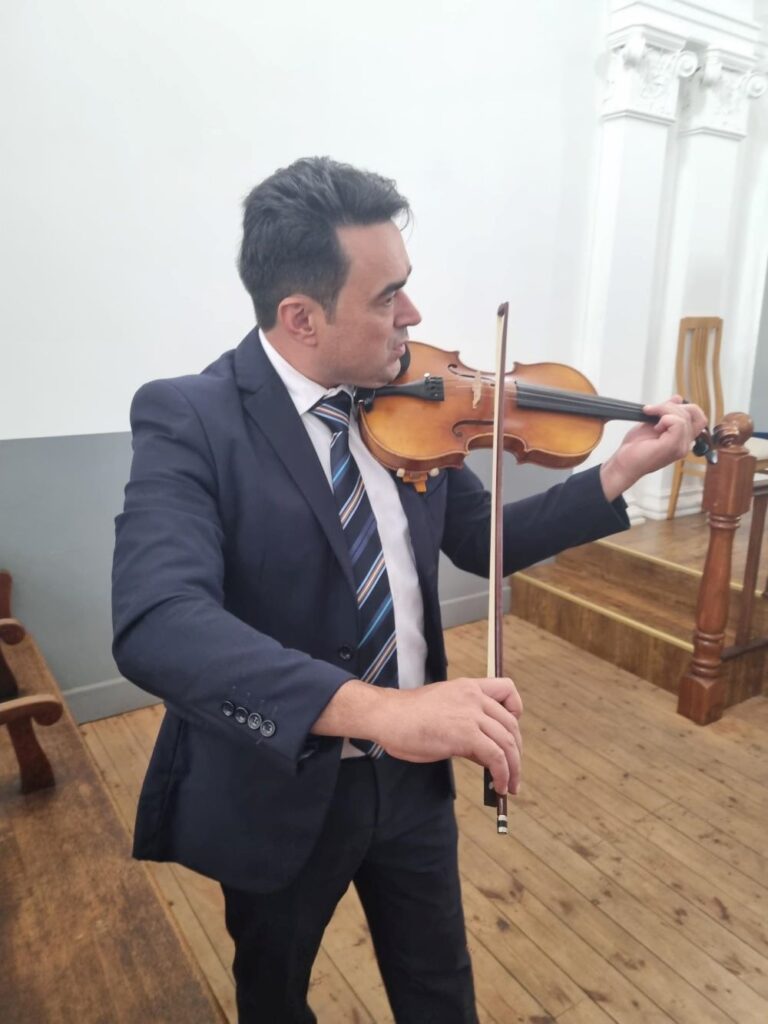 Roger violin smaller | Vox | IT Expertise Served with a Side of ‘Can-Do’ Attitude