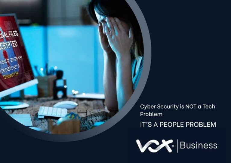 Stressed office worker holding their head at a desk while a computer screen shows a ransomware warning about encrypted files. Text reads: “Cyber Security is NOT a Tech Problem — IT’S A PEOPLE PROBLEM” alongside Vox Business branding.