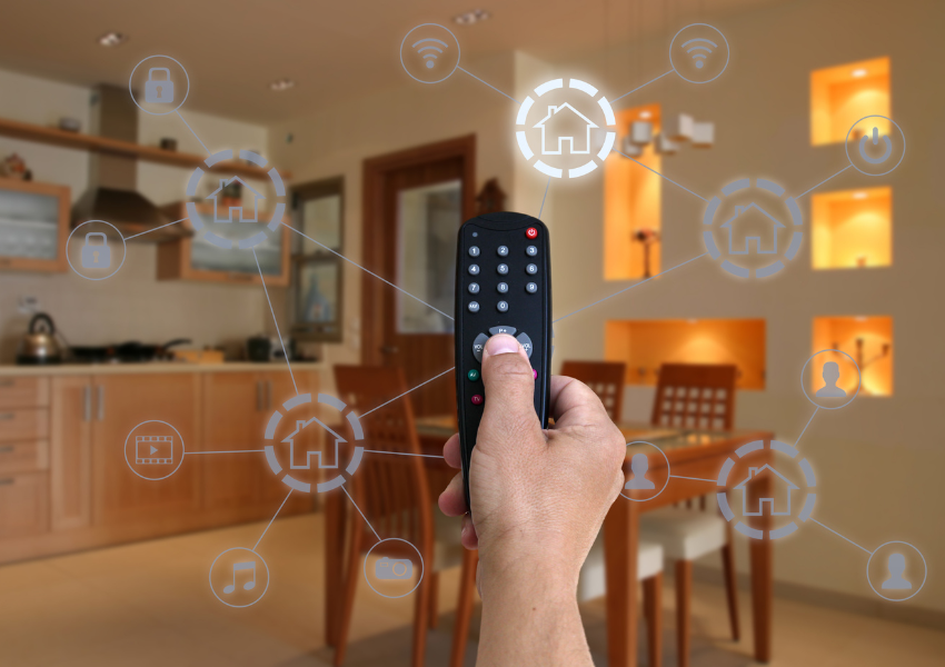Man holding remote interconnected to numerous Fibre applications
